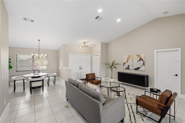 tiled living room with vaulted ceiling and a chandelier