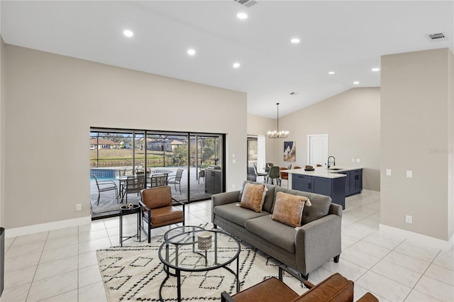 tiled living room featuring an inviting chandelier, high vaulted ceiling, and sink