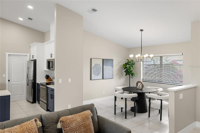 dining space with a chandelier, vaulted ceiling, and light tile patterned floors