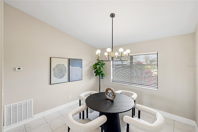 dining space featuring lofted ceiling and a chandelier