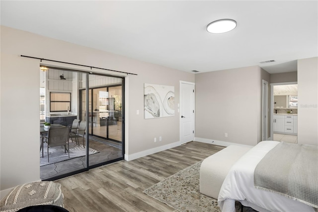 bedroom with access to exterior and light hardwood / wood-style flooring