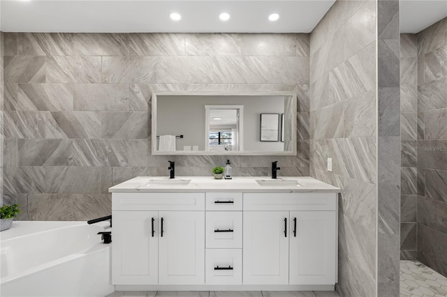 bathroom with vanity, tile walls, and plus walk in shower