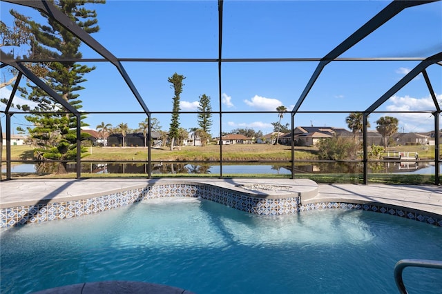 view of swimming pool featuring a water view, a patio, a jacuzzi, and glass enclosure