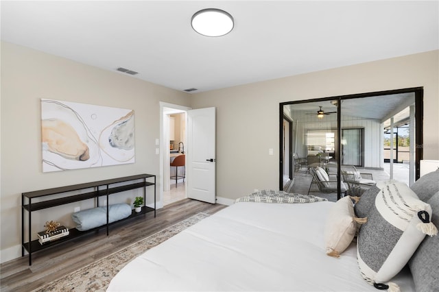 bedroom with wood-type flooring and access to exterior