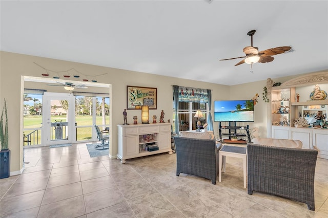 tiled living room featuring ceiling fan