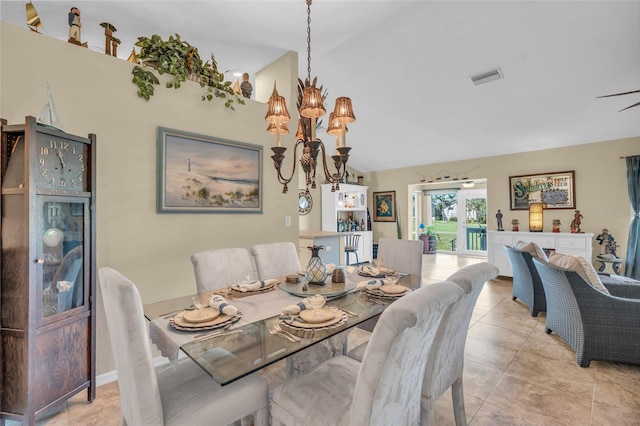 dining room featuring lofted ceiling, light tile patterned floors, and a notable chandelier