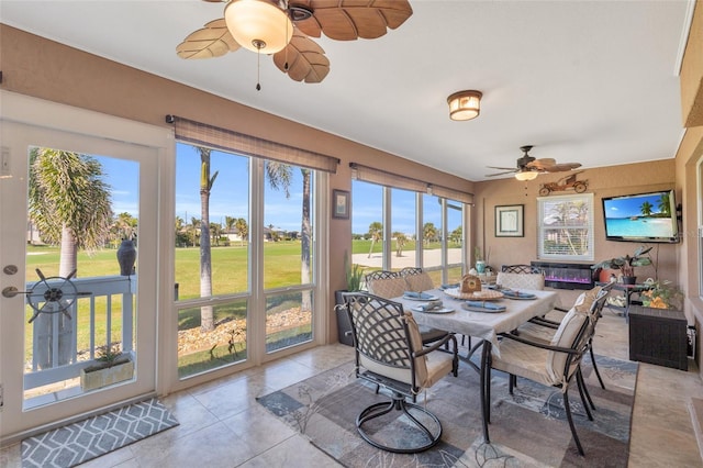 sunroom / solarium featuring ceiling fan