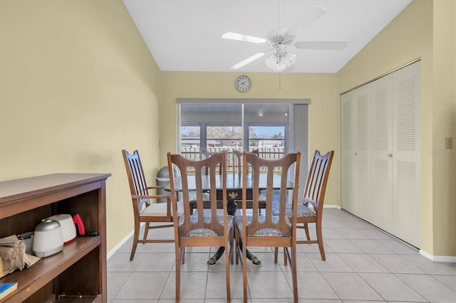 dining room with baseboards, a ceiling fan, and light tile patterned flooring