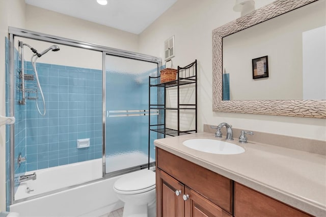 full bath featuring toilet, shower / bath combination with glass door, visible vents, and vanity