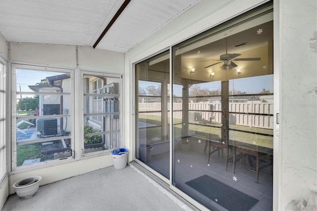 unfurnished sunroom with a ceiling fan