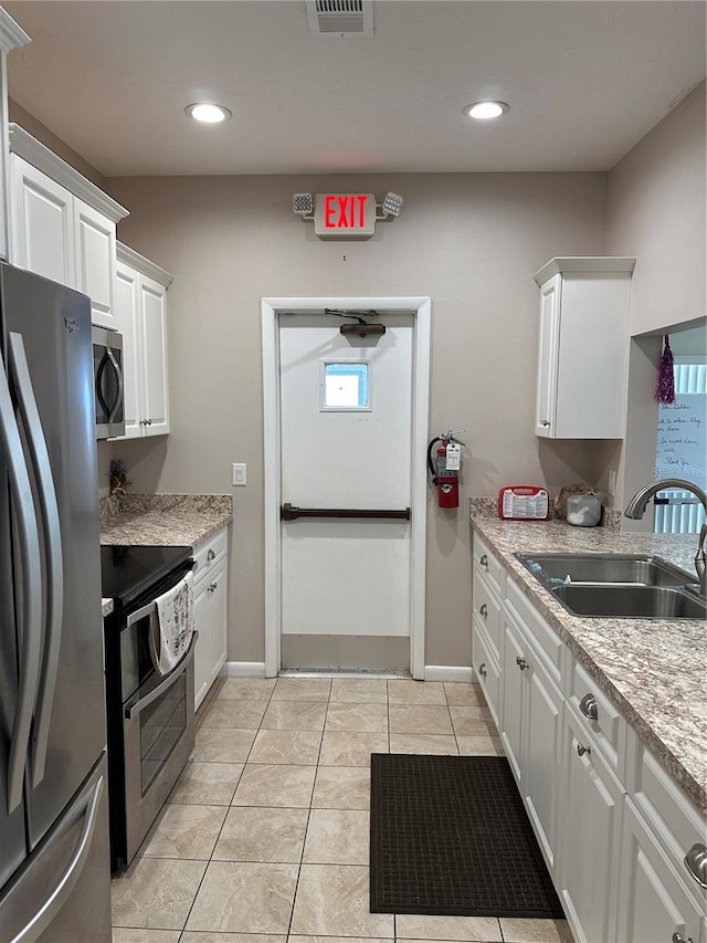 kitchen featuring stainless steel appliances, recessed lighting, visible vents, white cabinetry, and a sink