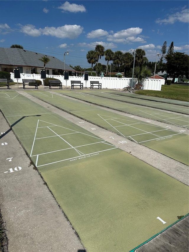 surrounding community featuring shuffleboard and fence