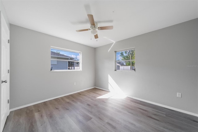 empty room with ceiling fan and wood-type flooring