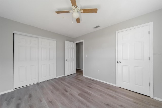 unfurnished bedroom with a closet, ceiling fan, and light hardwood / wood-style flooring