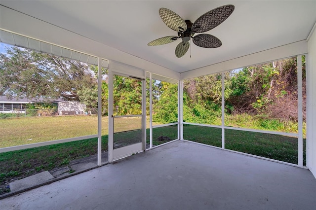 unfurnished sunroom featuring ceiling fan