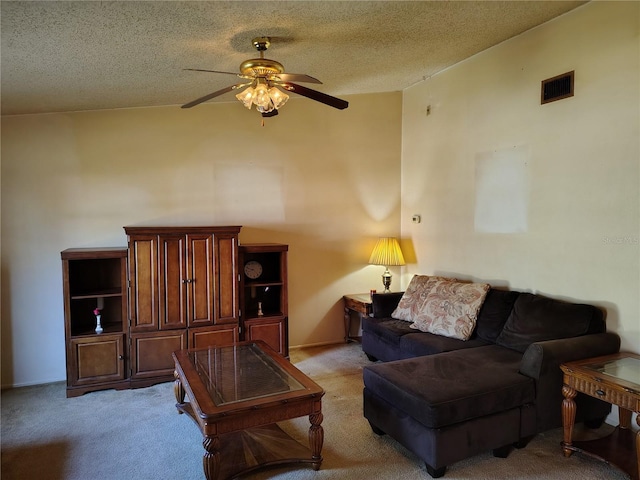 carpeted living room with ceiling fan, vaulted ceiling, and a textured ceiling