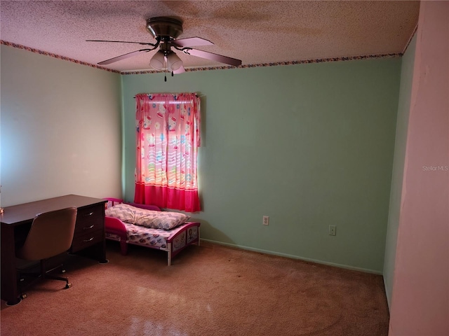 bedroom with ceiling fan, carpet floors, and a textured ceiling