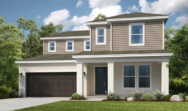 view of front of house with a garage and a front lawn