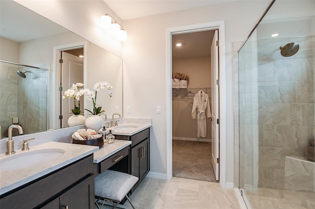 bathroom with vanity and a shower with door