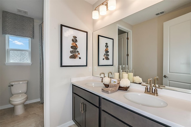 bathroom featuring vanity, toilet, and tile patterned flooring