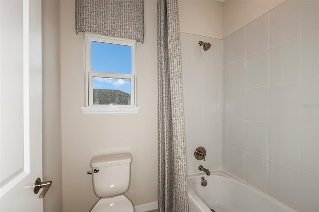 bathroom with shower / tub combo with curtain and toilet