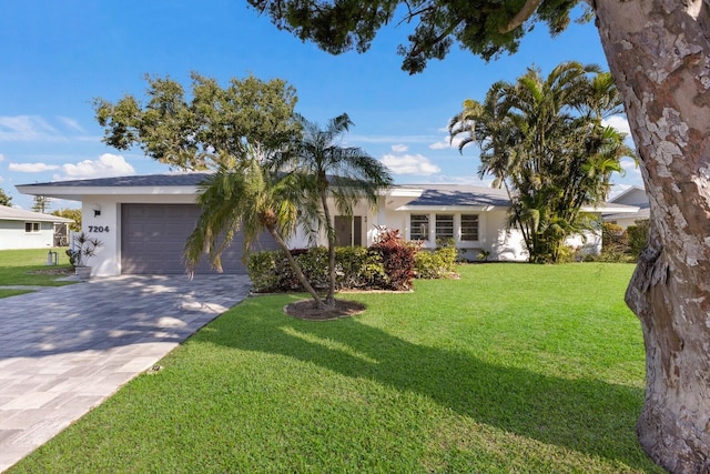 view of front of home featuring a garage and a front lawn