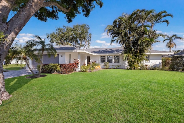 single story home featuring a garage and a front lawn