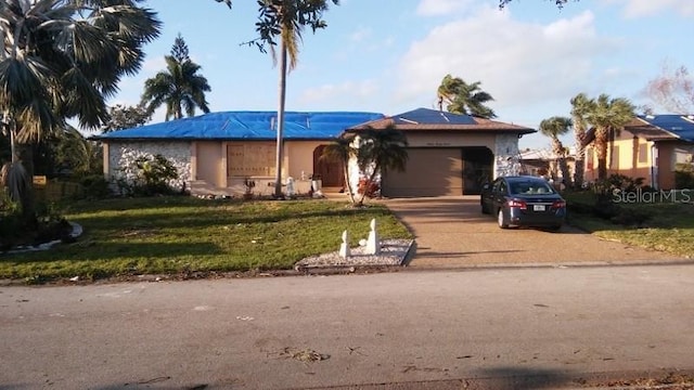 ranch-style home with a garage and a front yard