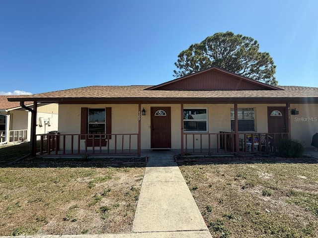 view of front of house with a front yard and a porch