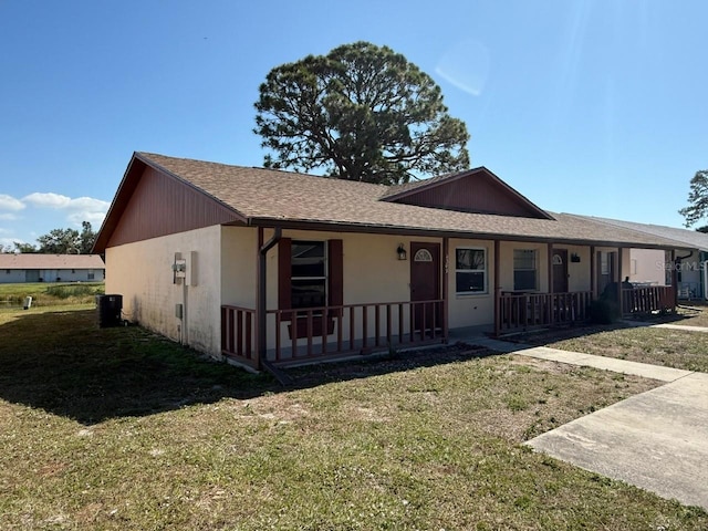 single story home with a porch, central AC unit, and a front lawn