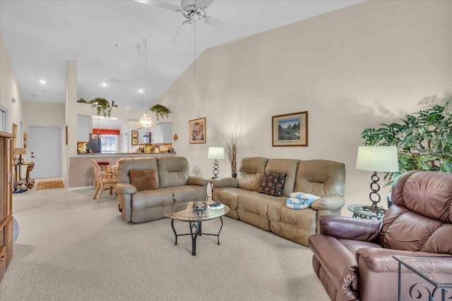 carpeted living room featuring ceiling fan and high vaulted ceiling