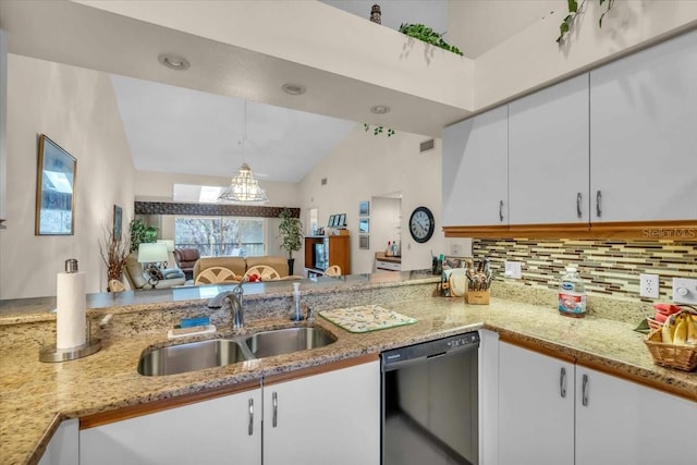 kitchen with vaulted ceiling, dishwasher, sink, white cabinets, and hanging light fixtures