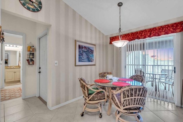 dining area with lofted ceiling and tile patterned flooring