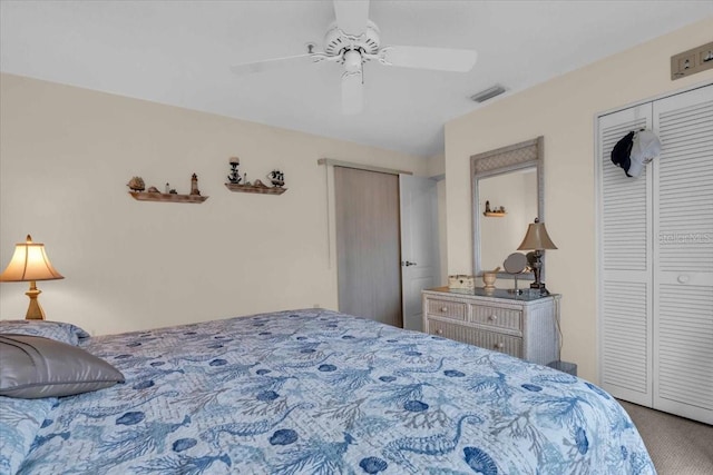 carpeted bedroom featuring multiple closets and ceiling fan