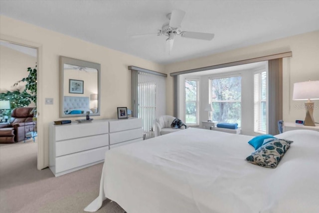 bedroom with light carpet and ceiling fan