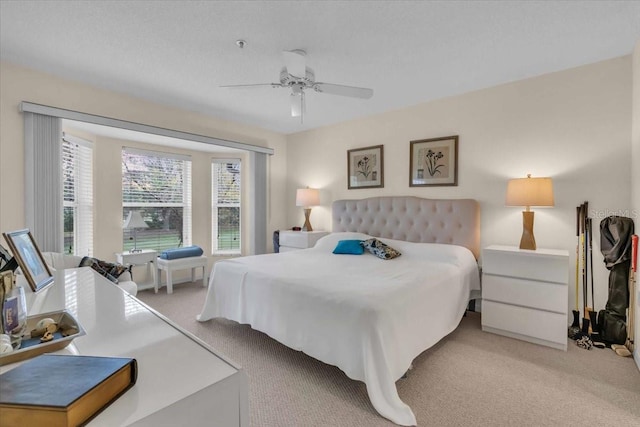 bedroom featuring light colored carpet and ceiling fan