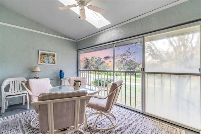 sunroom / solarium with lofted ceiling with skylight and ceiling fan