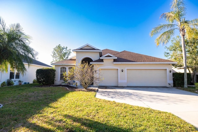 view of front of house featuring a garage and a front lawn