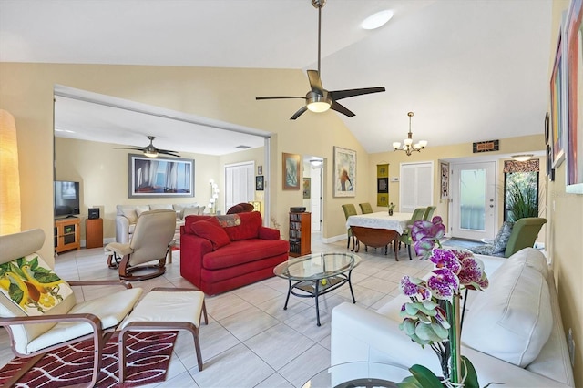 tiled living room with ceiling fan with notable chandelier and high vaulted ceiling