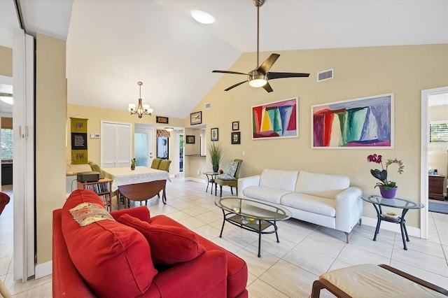 tiled living room featuring plenty of natural light, ceiling fan with notable chandelier, and high vaulted ceiling