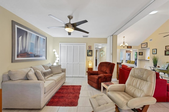 tiled living room with vaulted ceiling and ceiling fan with notable chandelier