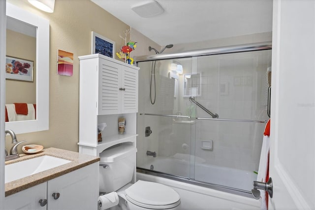 full bathroom featuring vanity, toilet, and combined bath / shower with glass door