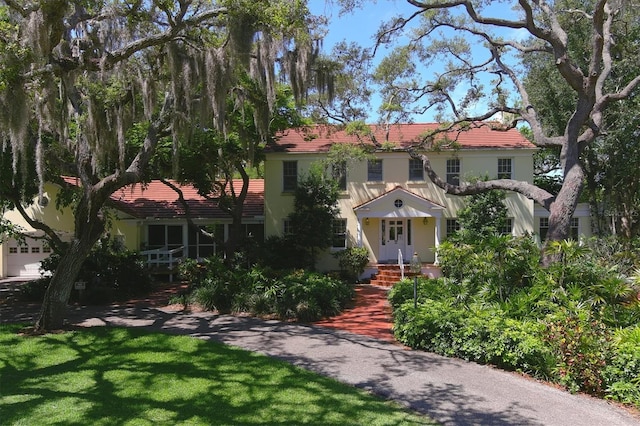 mediterranean / spanish-style home featuring a front lawn