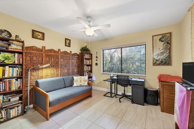 tiled home office featuring ceiling fan