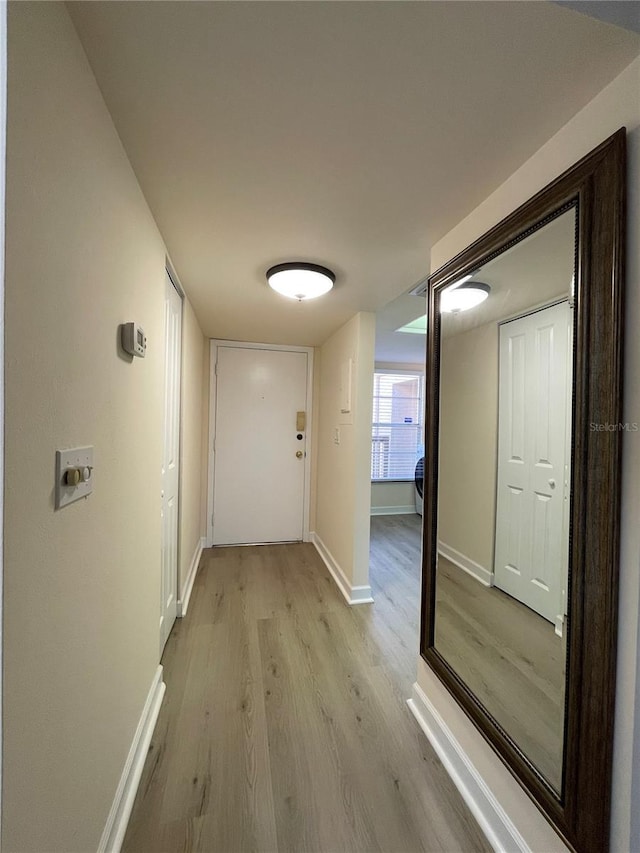 hallway with light hardwood / wood-style flooring