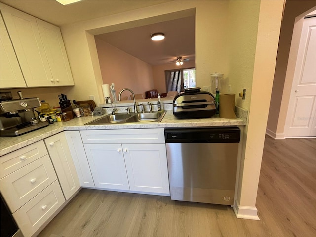 kitchen featuring light wood-type flooring, dishwasher, sink, and white cabinets