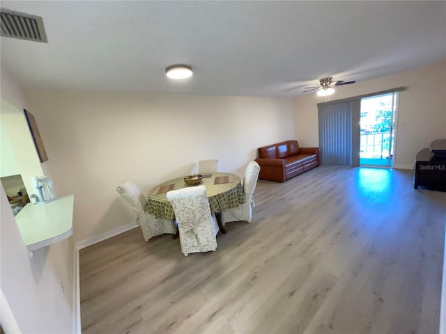 dining space featuring ceiling fan and light wood-type flooring