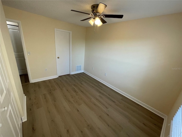 unfurnished bedroom with ceiling fan, hardwood / wood-style floors, and a textured ceiling