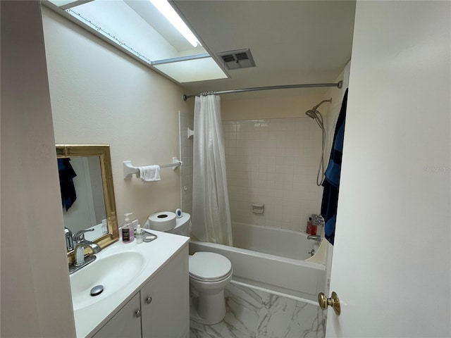 full bathroom featuring a skylight, shower / bath combo, vanity, and toilet