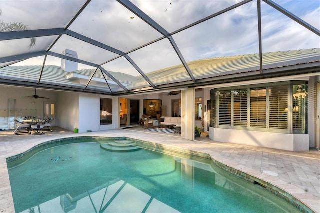 pool with a lanai, ceiling fan, an outdoor hangout area, and a patio